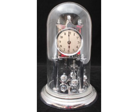 A 20th century chrome anniversary clock, the silvered dial with Arabic numerals denoting hours, under a glass dome.