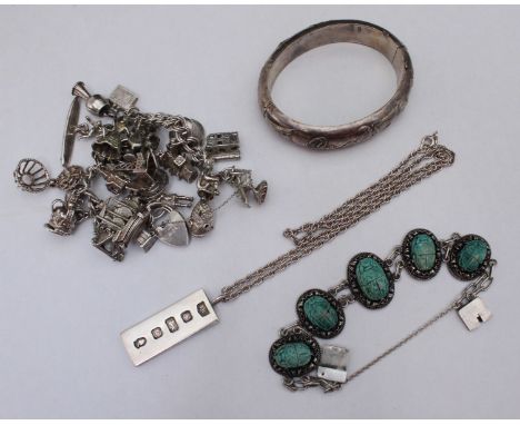 An assortment of silver items including a pair of cufflinks by 'Gieves' in original box, an ingot on chain, a Japanese stiff 