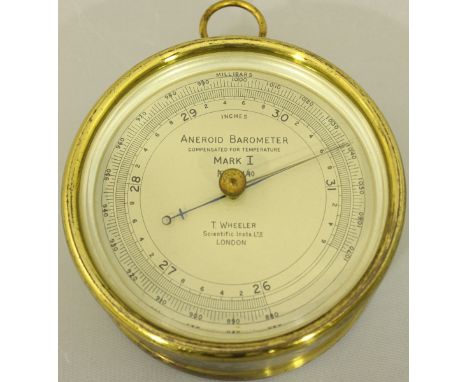 An aneroid barometer by T. Wheeler, London, Mark I, 11044/40, in circular lacquered brass case with suspension loop, 12cm dia