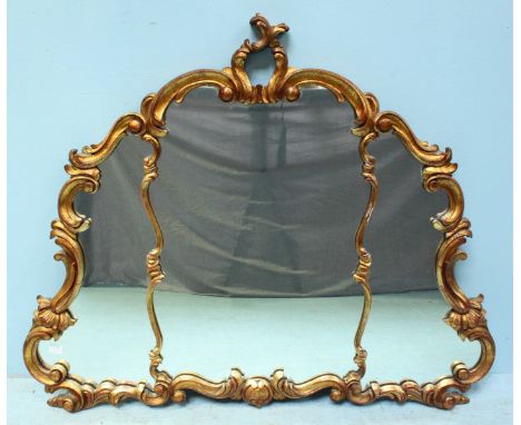 A Rococo style over-mantle mirror in carved and scrolling gilt frame. 90 x 110cm including frame.