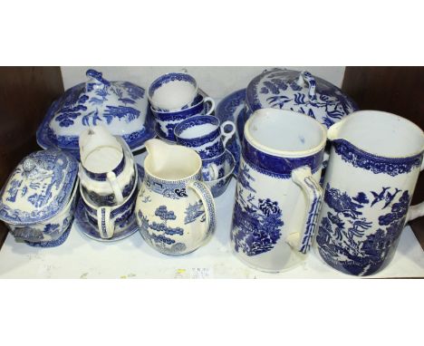 SECTIONS 10 + 11. A good quantity of willow pattern dinner and tea wares, comprising of meat plates, tureens, jugs, cups and 