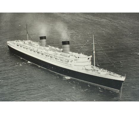 A large monochrome portrait of the cruise ship Queen Elizabeth, taken at anchor showing an aerial view of her starboard and b