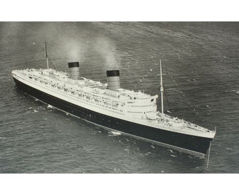 A large monochrome portrait of the cruise ship Queen Elizabeth, taken at anchor showing an aerial view of her starboard and b