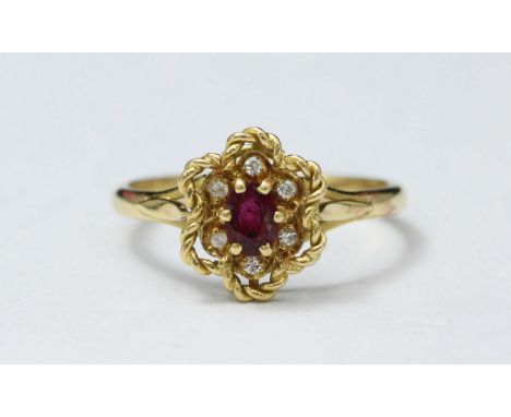 An 18ct gold, ruby and diamond cluster ring, centrally claw-set an oval ruby surrounded by six small diamonds with rope-twist