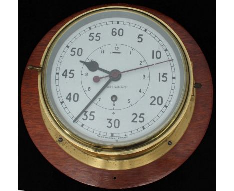An Admiralty pattern brass ship's bulkhead clock, 0552/ 461-9413, white dial with small inner hour chapter ring and larger ou