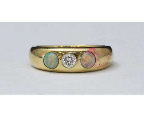 An 18ct gold diamond and opal gypsy 'style' ring, plain band centrally set with a rbc diamond estimated 0.25cts, flanked by t