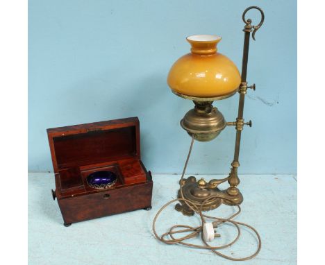 A 19th Century mahogany sarcophagus shaped tea caddy and a brass electric lamp, modelled as an oil lamp.