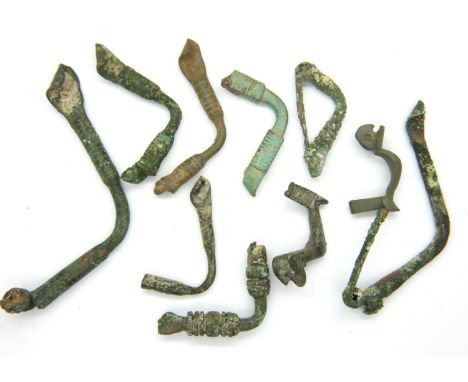 Ten Roman Bronze Age cloak fibulae. P&amp;P Group 1 (£14+VAT for the first lot and £1+VAT for subsequent lots) 
