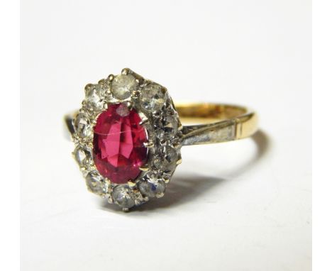 Pink stone and diamond cluster ring set oval facet-cut pink stone, having surround of ten diamonds 