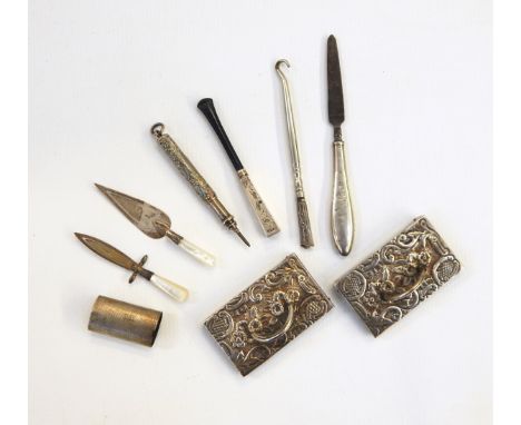 Pair of silver place name holders, the rectangular bases with embossed floral decoration, 7cm long, silver mounted cheroot ho