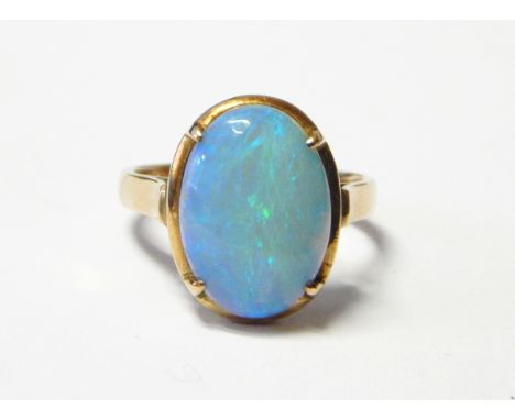 Gold and opal ring, the oval opal cabochon in four-claw setting, marked 14K 