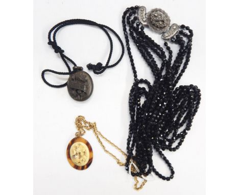 Five-row necklace of French jet beads, with silver clasp, Victorian souvenir locket and tortoiseshell and carved bone pendant