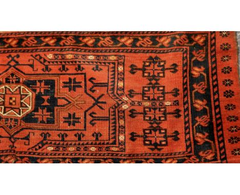 Eastern wool runner with red ground, geometric patterns and black guard stripes and another rug (2)  Live Bidding: Runner pro