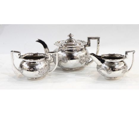 Chinese silver three-piece teaset comprising teapot, two-handled sugar bowl and milk jug, each of circular form decorated wit