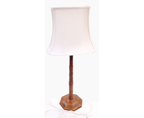 Gimson walnut table lamp having tapered and ring turned octagonal column with lozenge faceted centre section, on domed octago