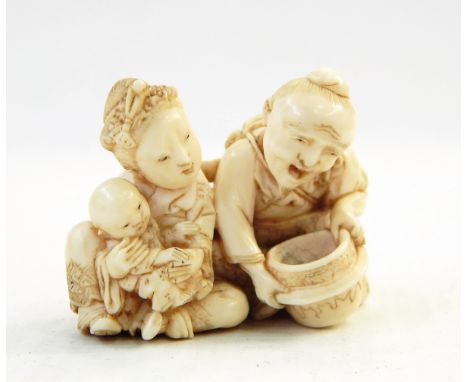 Japanese carved ivory netsuke, husband and wife with baby, signed, 3cm high 