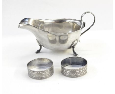 Silver sauce boat by Mappin & Webb, Sheffield 1927 and pair of silver napkin rings with engine-turned decoration 