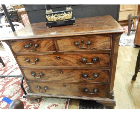 George III inlaid mahogany chest of two short and three long drawers, with brass bail handles, chamfered canted corners, on o