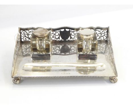 Silver inkstand by A & J Zimmerman Limited, Birmingham 1919, of rectangular form with three-quarter gallery with pierced scro