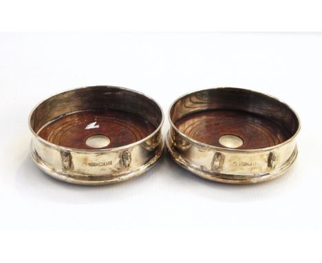 Pair of modern Britannia standard silver wine coasters by Francis Howard Limited, Sheffield 2004 of plain circular form with 