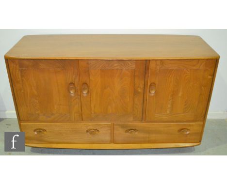 Ercol - A Windsor elm and beech sideboard, model 468, fitted with an arrangement of three doors above two drawers, fitted wit