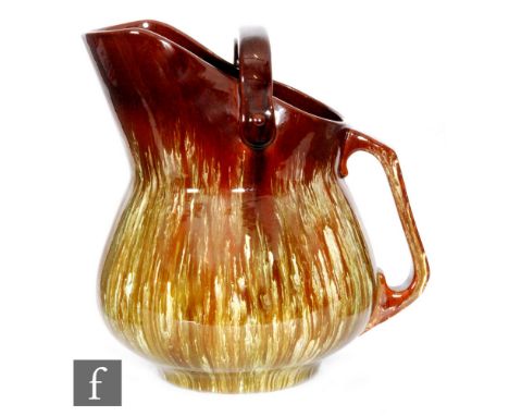 Burmantofts Pottery - In the manner of Chistopher Dresser, a jug in the form of a coal scuttle, the treacle glaze, with runni