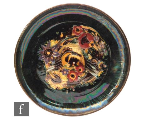 Christopher Dresser - Linthorpe Pottery - A 19th Century dish of circular form, the central reserve incised with birds and fo