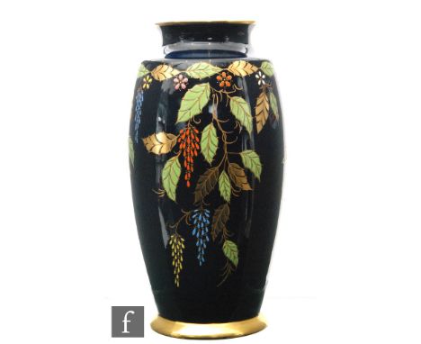 Carlton Ware - A 1930s Art Deco vase of footed barrel form decorated in the Leaf pattern with gilt and enamel foliage against