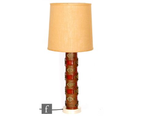 Unknown - A metal table lamp of abstract column form, decorated in relief and complete with a hopsack style cylindrical shade