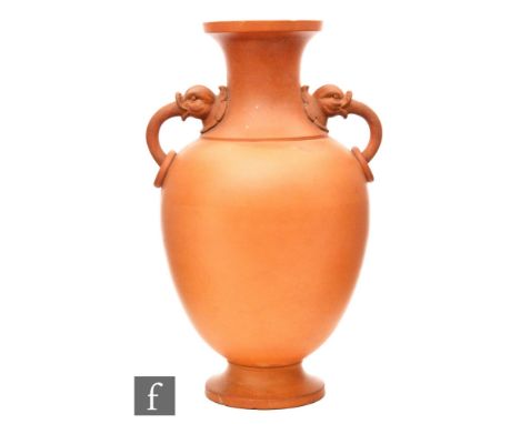Attributed to Christopher Dresser - Watcombe Pottery - A late 19th Century terracotta vase the baluster vase rising from a sp