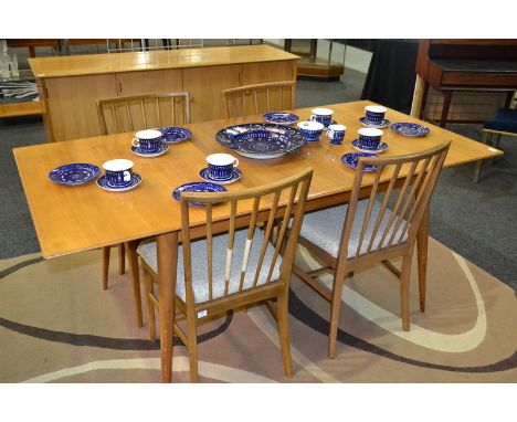 In the manner of Gordon Russell Furniture - A composed dining suite to comprise walnut and beech sideboard, fitted with a dou