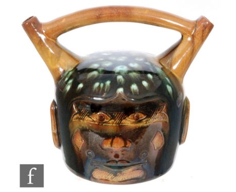 Christopher Dresser - Linthorpe pottery - A late 19th Century vase, of Peruvian influence, incised with a mask with an upper 