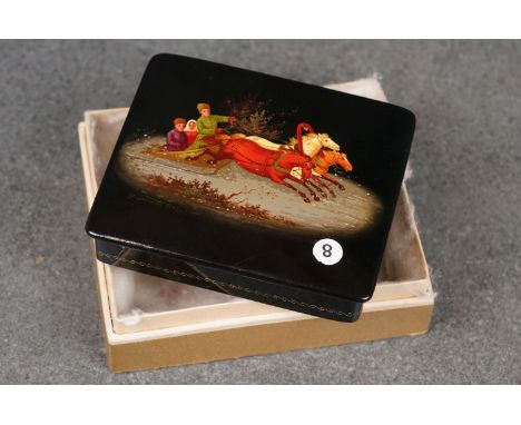 A Russian papier mache snuff box with decorative panel to lid, marked made in USSR to base. 