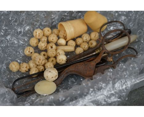 A small box of collectables to include button hooks, sewing scissors, ivory thimbles and beads. 