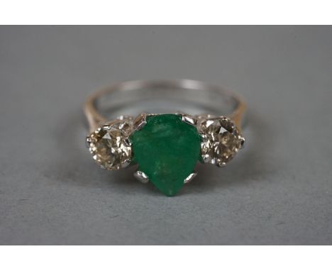 18ct white gold pear shaped emerald and diamond three stone ring 