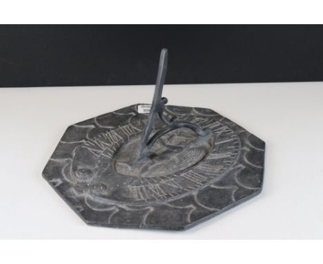 Octagonal lead sundial with winged figure to centre, approx. 30cm diameter 