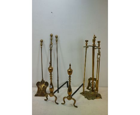 A early 20th century fireside companion set together with a pair of fire dogs and a quantity of tools. 