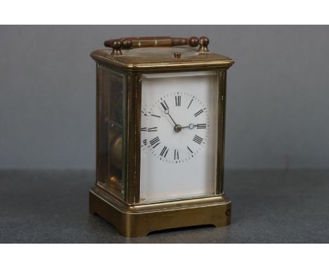 A vintage brass cased carriage clock with white enamel dial. 