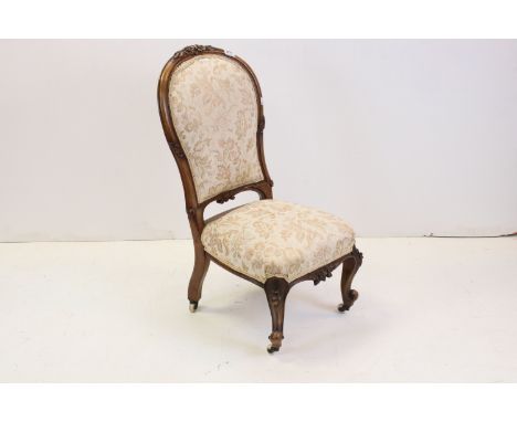 Victorian Walnut Framed Spoon Back Nursing Chair raised on ceramic castors, 87cms high 