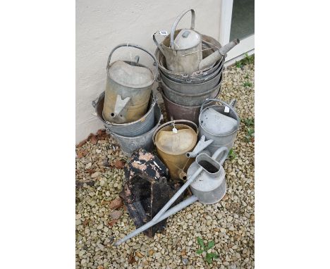 A collection of vintage galvanised steel buckets and watering cans together with two drain hoppers. 