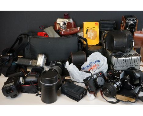 A large collection of vintage cameras and photographic equipment to include Cameras, Lenses, filters, flashguns and gadget ba