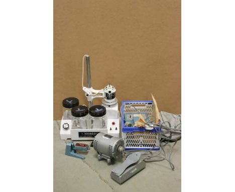 A collection of watch and clock repair tools contained within two boxes. 