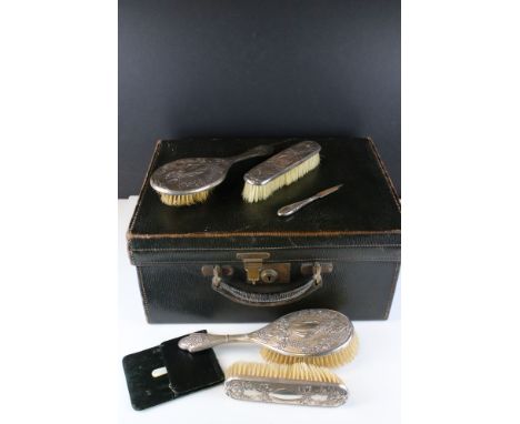 A vintage green leather fitted vanity case by J.W. Benson together with a fully hallmarked sterling silver brush set. 