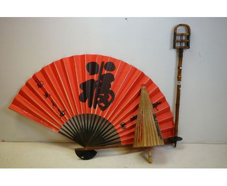 A vintage bamboo hunting stick together with a large oriental fan and a parasol 