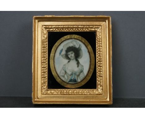 A hand painted miniature portrait of a lady within a gilt frame. 