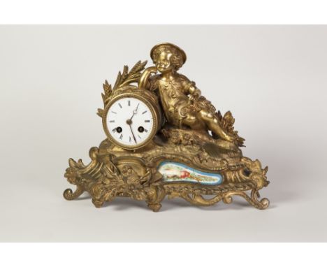 LATE NINETEENTH CENTURY FRENCH GILT METAL AND PORCELAIN MOUNTED FIGURAL MANTEL CLOCK, the 3 1/4" enamelled Roman dial powered