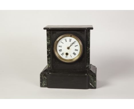 LATE VICTORIAN BLACK SLATE MANTEL CLOCK, the 3 1/2" enamelled Roman dial powered by a drum shaped movement and housed in a fl