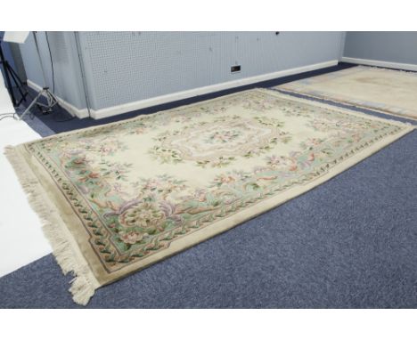 GOOD QUALITY EMBOSSED WASHED CHINESE CARPET OF AUBUSSON DESIGN with large centre floral oblong panel within a scroll border o