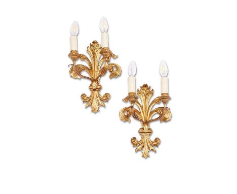 A pair of Italian carved giltwood fleur-de-lys twin-light wall lights

Fitted for electricity, each 34cm high.
