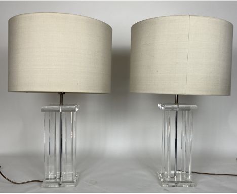 A pair of contemporary Art Deco style clear perspex table lamps and a pair of glass table lamps
The square tops above four su